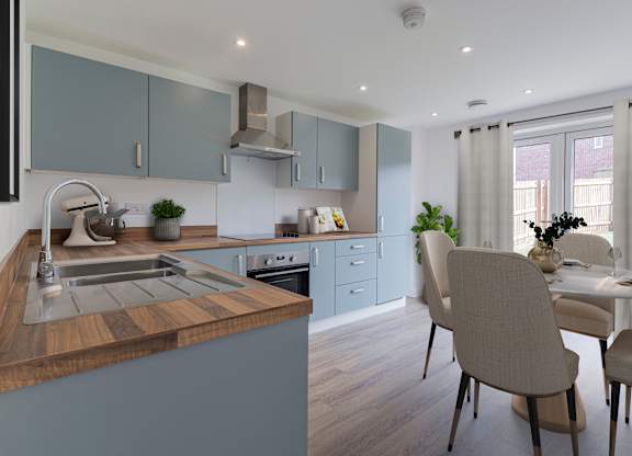 A modern kitchen with a wooden island and grey cabinets.