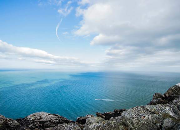 A view of a rocky coastline with a body of water and a partly cloudy sky. at Cherrywood Apartments, D18 VY3V