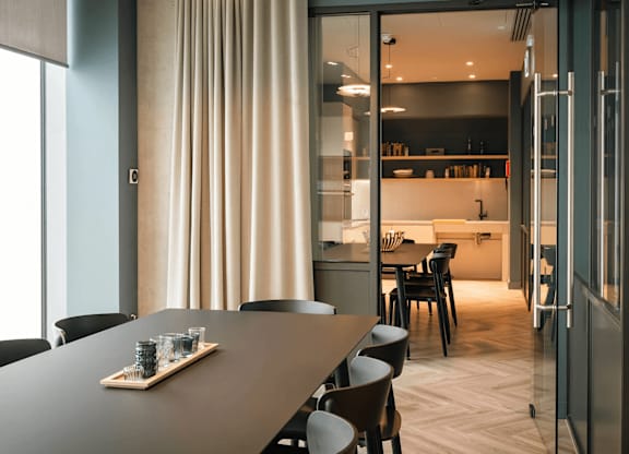 A modern dining room with a long table and chairs. at Cherrywood Apartments, D18 VY3V, DUBLIN 18