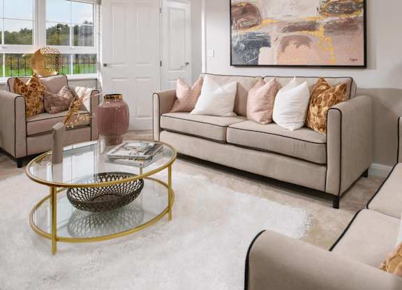 A living room with a large painting on the wall and a glass coffee table in the center.