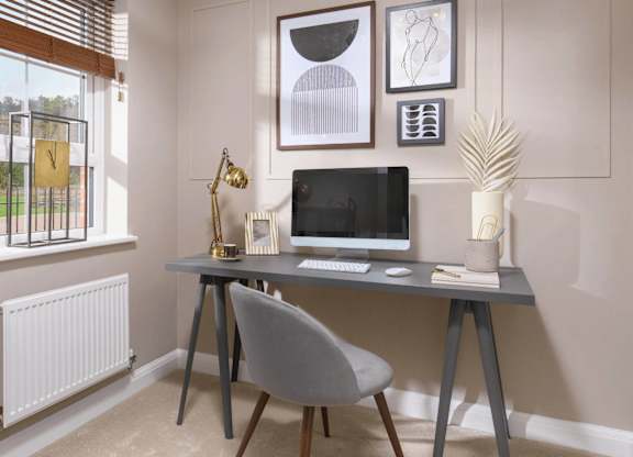 A modern home office with a desk, chair, and a window with blinds.