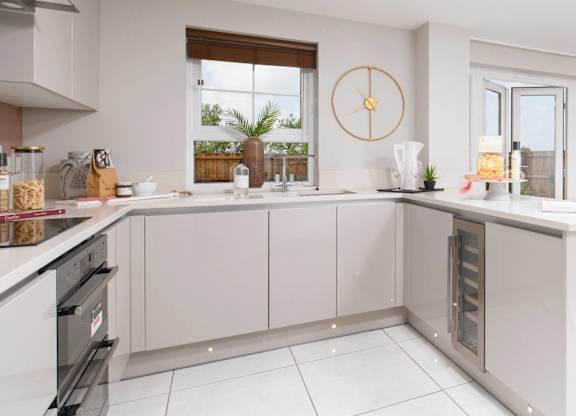 A modern kitchen with a large window and a clock on the wall.