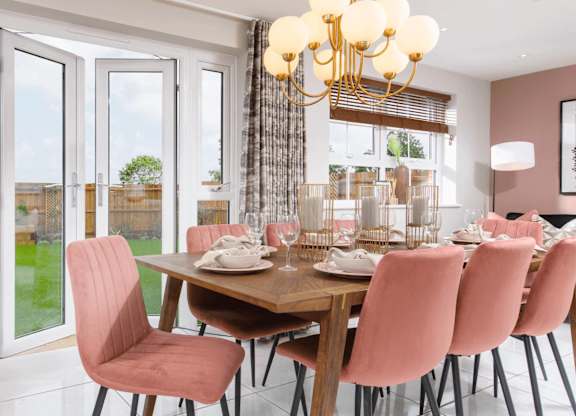 A dining room with a wooden table and chairs.