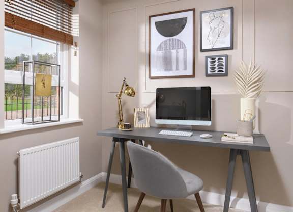 A modern home office with a desk, chair, and computer.