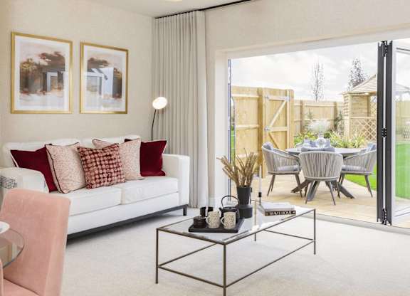 A modern living room with a white sofa and a glass coffee table.