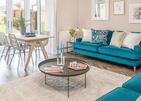 A living room with a blue couch and a coffee table.
