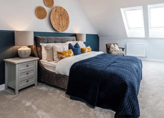 A bedroom with a large bed and a chandelier.