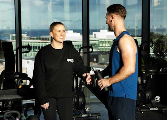 A man and a woman in a gym, the woman is wearing a black Nike sweatshirt and the man is wearing a blue sleeveless shirt at Cherrywood Apartments, D18 VY3V, DUBLIN 18