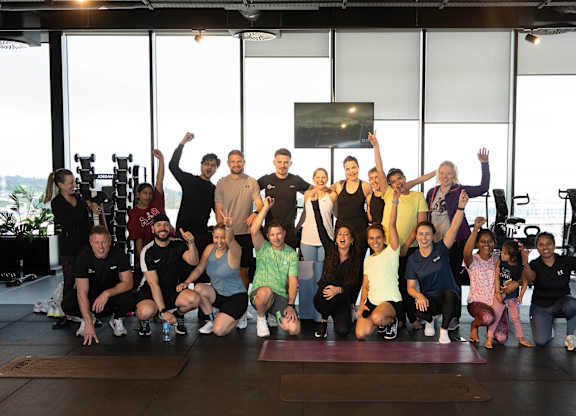 A group of people are posing for a photo in a gym at Cherrywood Apartments, D18 VY3V