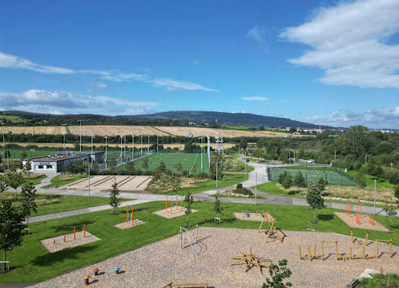 A playground with a swing set and slides at Cherrywood Apartments, D18 VY3V