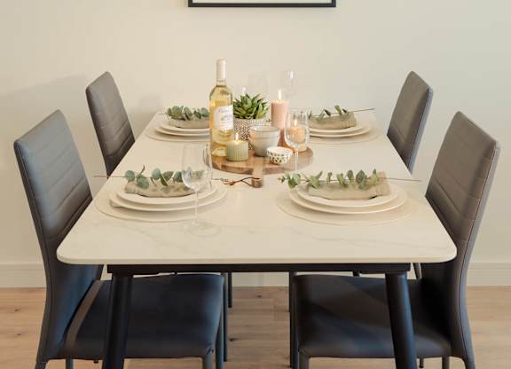 A dining table set with plates and glasses with a painting hanging on the wall at Cherrywood Apartments, D18 VY3V, DUBLIN 18