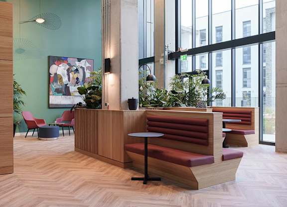 A reception area with a wooden bench and a green wall at Cherrywood Apartments, D18 VY3V