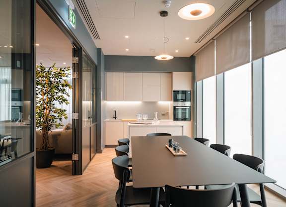 A modern dining area with a long table and chairs at Cherrywood Apartments, D18 VY3V