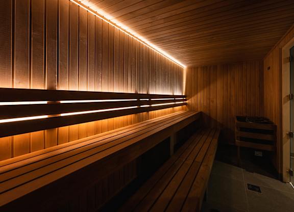 A sauna with wooden benches and walls, illuminated by a row of lights at Cherrywood Apartments, D18 VY3V, DUBLIN 18