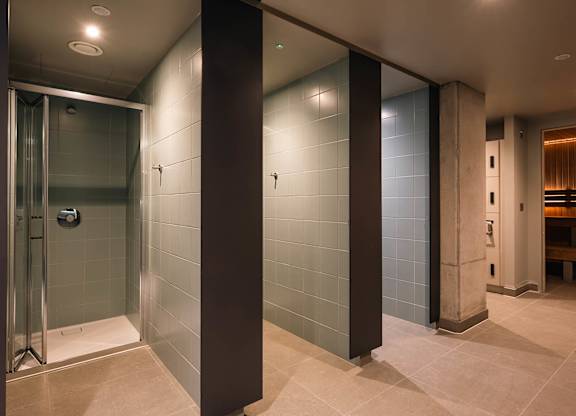 A bathroom with a glass shower stall and a bench at Cherrywood Apartments, D18 VY3V, DUBLIN 18