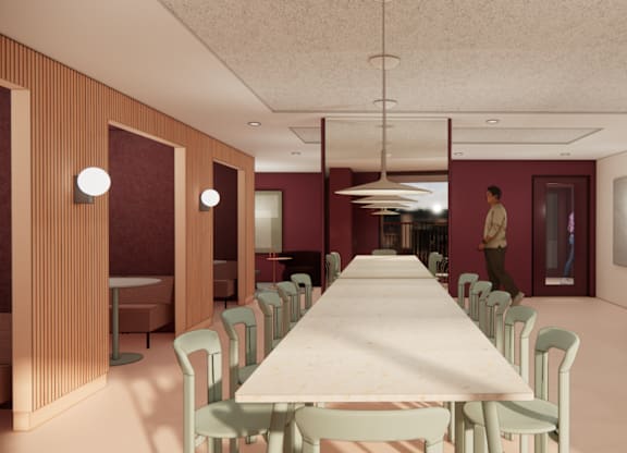 A long table with chairs is in the middle of a room.
