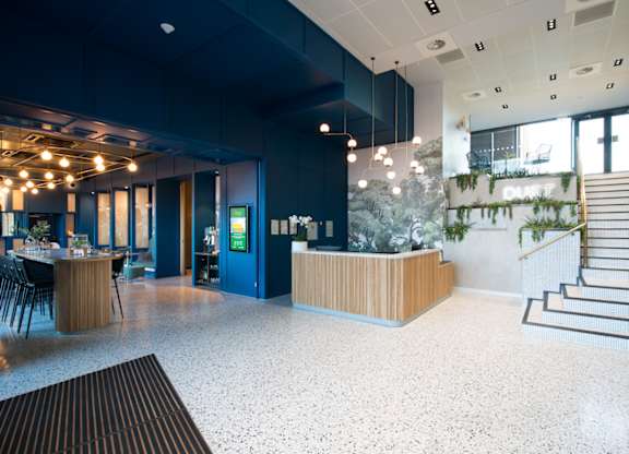 A reception area with a staircase leading to the upper floor.