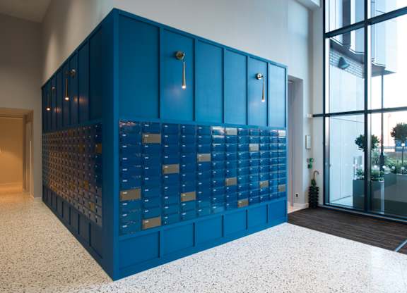 A blue cabinet with a glass door is in the middle of the room.