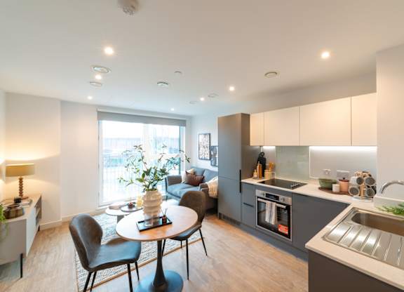 A modern kitchen with a dining table and chairs.