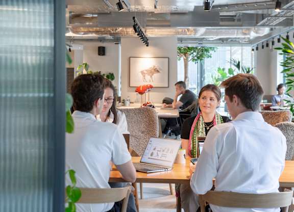 Group of people sitting around table in modern office at The Lark, London, SW11 7EA