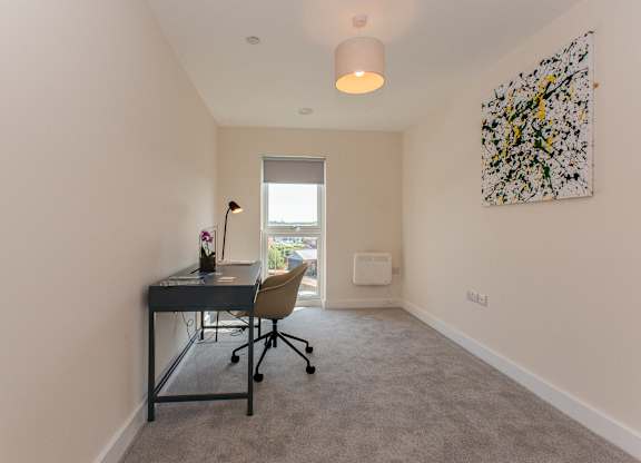 A room with a desk and a chair.