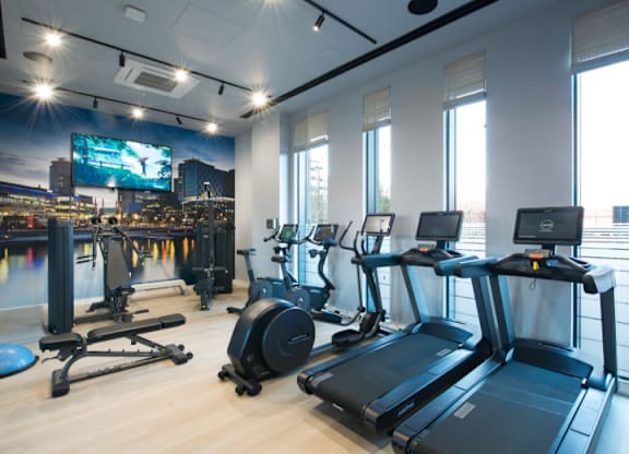 A gym with treadmills and exercise bikes.