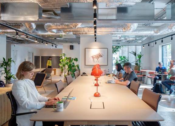 Co-working space with a long table and chairs at The Lark, London, SW11 7EA