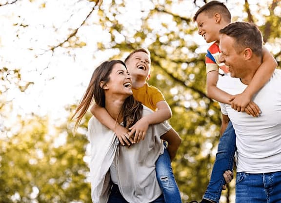 A family of three is having fun outdoors at Origins Apartments, Cambridge