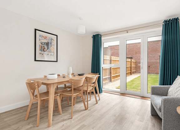 A dining room with a wooden table and chairs at Origins Apartments, Cambridge