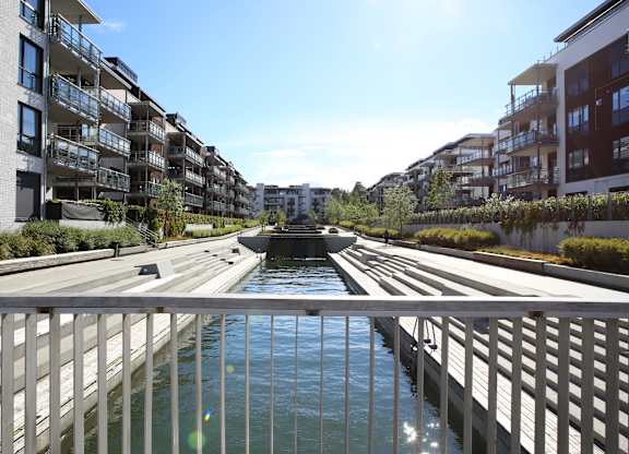 A view of a canal with apartment buildings on both sides.