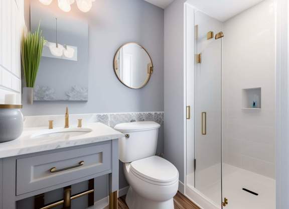 A bathroom with a toilet, sink, and shower.