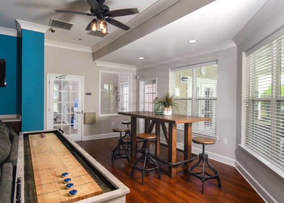 a game room with a pool table and a bar