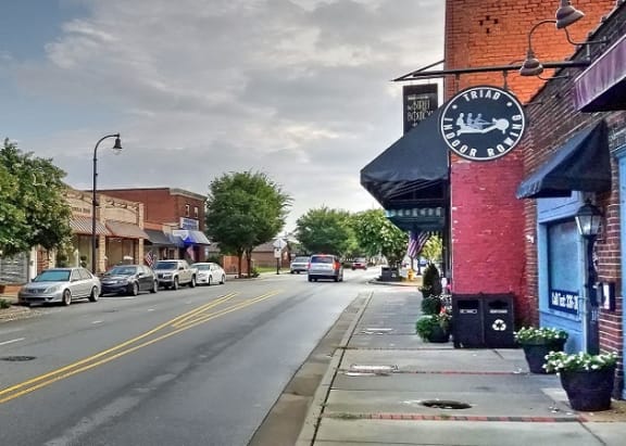 a city street with cars parked on the side of the road