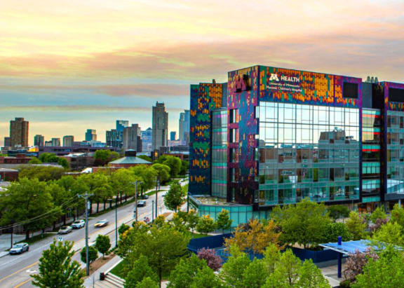 an aerial view of a building with a city skyline in the background