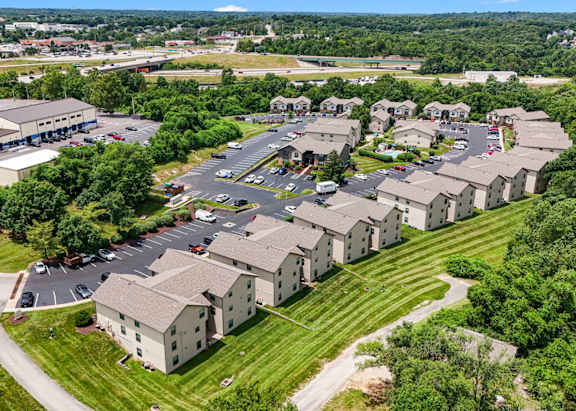 A bird's eye view of a residential area with houses and a parking lot.