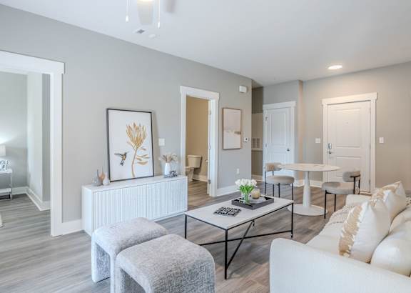 a living room filled with furniture and a ceiling fan