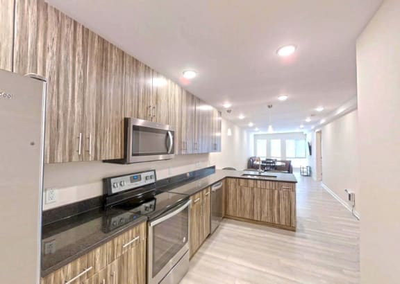 a kitchen with wooden cabinets and a stove and a microwave