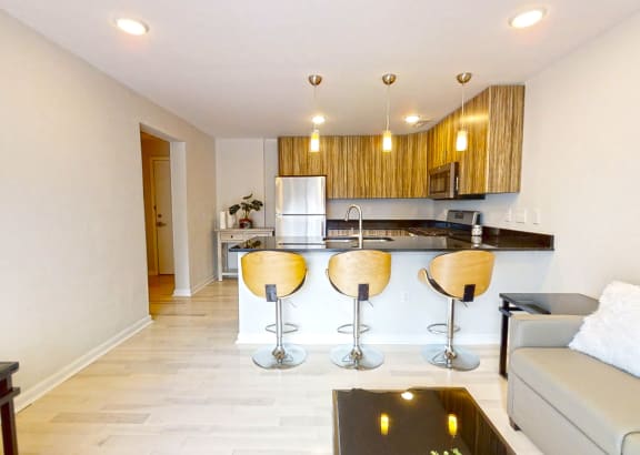 a kitchen with a bar and a living room