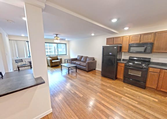a kitchen and living room with wood flooring and