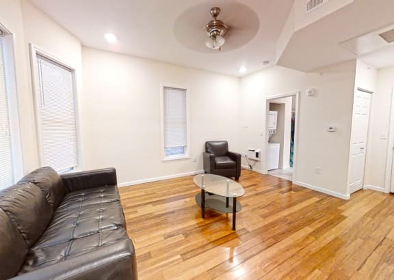 a living room with a leather couch and a coffee table