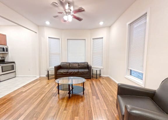 a living room with leather couches and a table