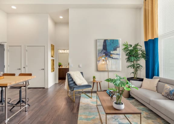 a living room with a couch and a dining table