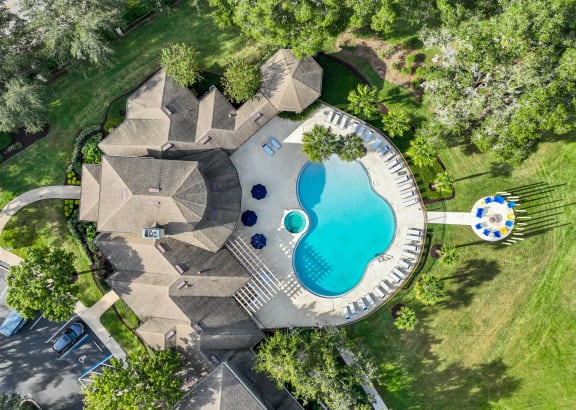 a backyard pool with a pool house and a swimming pool