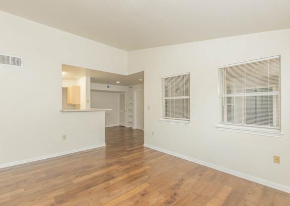 A room with wooden floors and white walls.