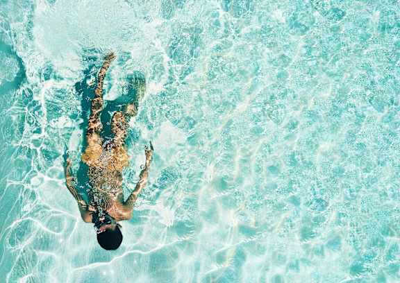 A man swimming in a pool.