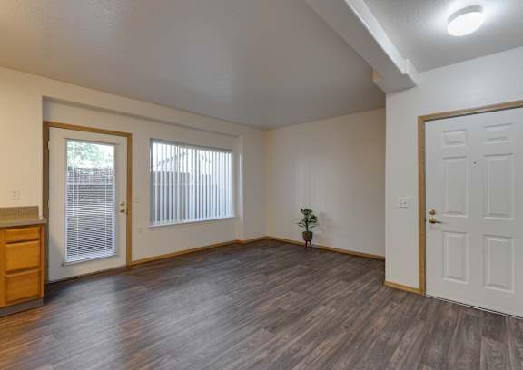 A room with a window and carpeted floor.
