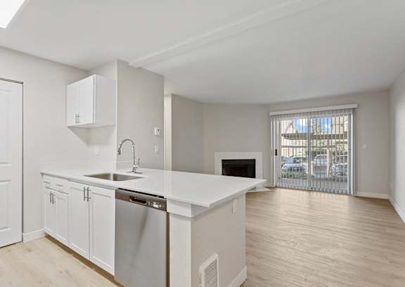 A kitchen with white cabinets and a large island at MonteVista Apartments, Beaverton