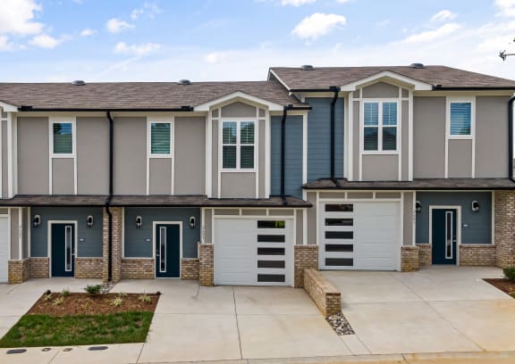 a row of townhomes with blue doors and windows