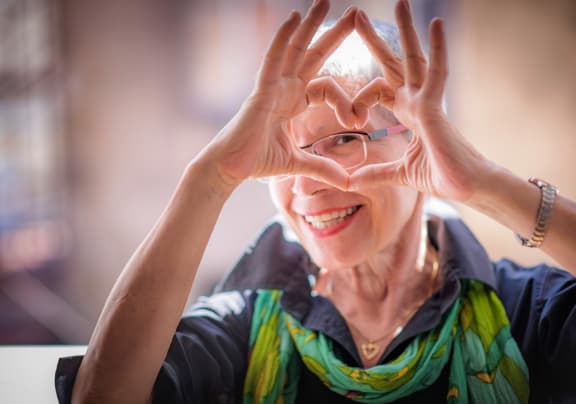 a woman making a heart shape with her hands at Arbor Hills, Lakeland
