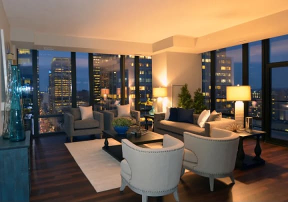 a living room with a view of the city at night